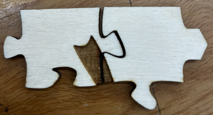 Two puzzle pieces with a few small gaps where the pieces should be fitting well together.