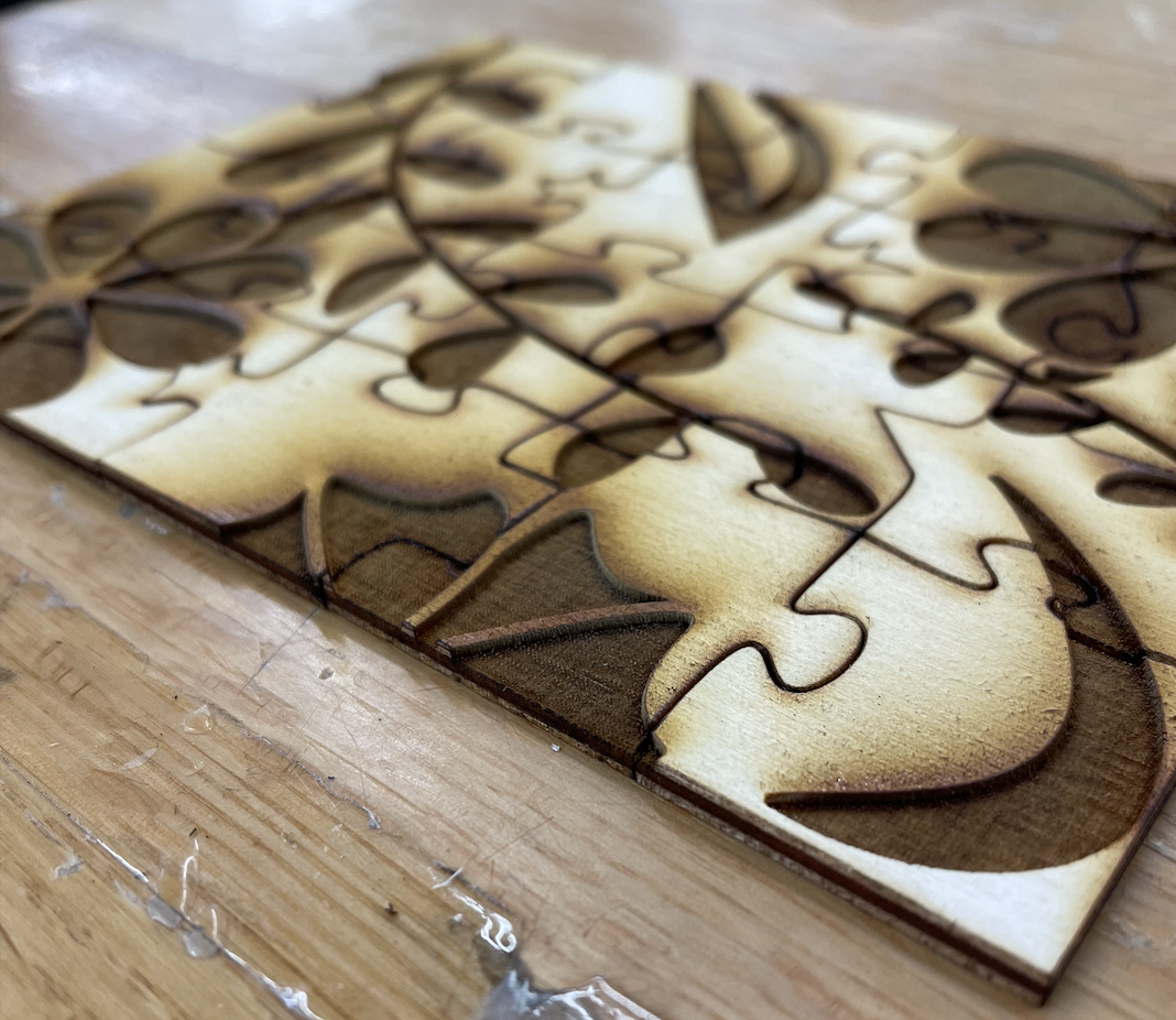 Tilted view of the twenty-piece laser cut tactile puzzle. Its tactility is clearly visible.